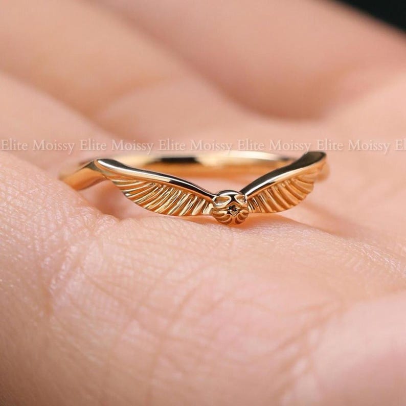 Engraved 14k gold wing band with filigree details, minimalist vintage inspired stacking wedding ring worn on finger.