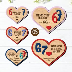 May include: Wooden heart-shaped decorations with the numbers 6 and 7, and the text "Friends Stick Together Like" and "From Score of 1-5, You Are My". The hearts have red, blue, and pink borders, with a wooden grain background. The text "Happy Valentines Day" is also included.