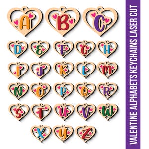 May include: A collection of laser-cut wooden alphabet keychains in a heart shape. Each letter is a different colour and decorated with small pink hearts. The text on the side says "VALENTINE ALPHABETS KEYCHAINS LASER CUT".
