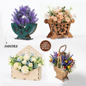 May include: Four laser-cut wooden mini baskets, each holding artificial flowers. The designs include a half-moon, an envelope, and a handled basket. The flowers are in shades of purple, pink, white, and yellow. The text "3MMFILE" is visible.