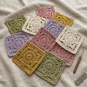 May include: A collection of square crochet motifs in various colors including olive green, mustard yellow, cream, lavender, and dusty rose. Each piece features a circular floral pattern. A wooden crochet hook and a tag labeled Willow's Crochet are included.