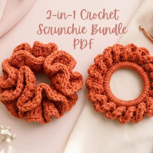 May include: Two orange crochet scrunchies, one bunched and one circular, with the text "2-in-1 Crochet Scrunchie Bundle PDF." A ball of orange yarn and two crochet hooks are also visible. The scrunchies are on a light pink surface.