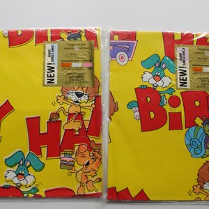 May include: Two rolls of yellow birthday wrapping paper with colorful cartoon animals and the words "Happy Birthday". Each roll has a gold label that says "New! Giant Single Sheet Gift Wrap 25 sq ft (2.3 sq m) 13 ft x 1.9 yds".