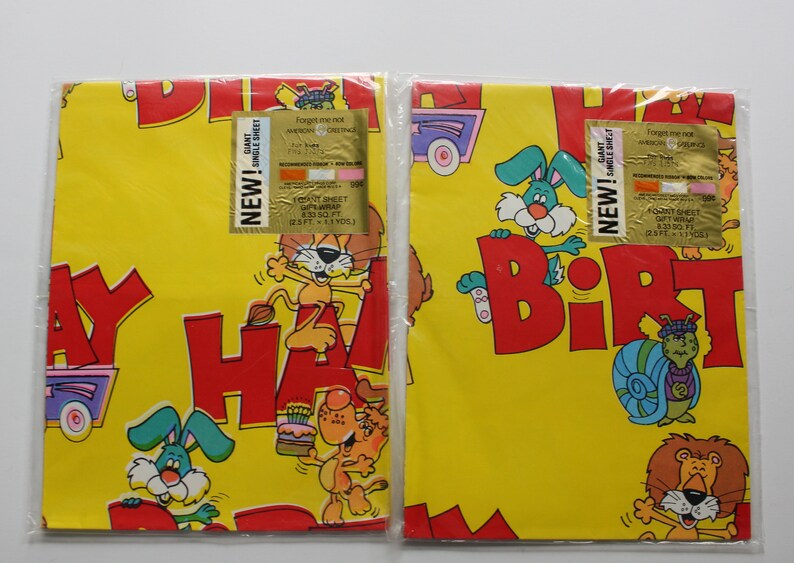 May include: Two rolls of yellow birthday wrapping paper with colorful cartoon animals and the words "Happy Birthday". Each roll has a gold label that says "New! Giant Single Sheet Gift Wrap 25 sq ft (2.3 sq m) 13 ft x 1.9 yds".