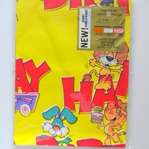 May include: A yellow and red birthday wrapping paper with a giant sheet size of 8.33 square feet. The paper features a cartoon design with animals and the words "Happy Birthday".