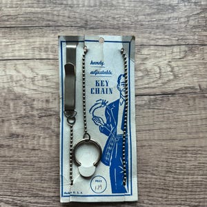 May include: A set of three ceramic mugs with a speckled, matte finish. The mugs are in shades of cream, light gray, and dark gray. Each mug has a simple, minimalist design and a rounded handle.