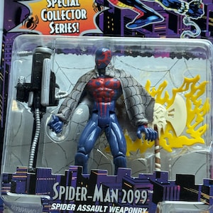 May include: Spider-Man 2099 action figure in a plastic package. The figure is blue with red accents and a gray webbed cape. It includes a black weapon and a yellow and white axe. The packaging reads "Special Collector Series!"