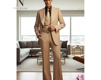 May include: A beige three-piece suit featuring a wide lapel blazer, waistcoat, and flared trousers. The suit is worn with a brown shirt and tie. The image includes the text "THE NOOR" and a logo.