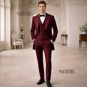 May include: A three-piece burgundy suit with a black bow tie. The suit includes a long-line jacket, vest, and trousers. The image also displays the word "NOOR". The man is wearing black dress shoes.