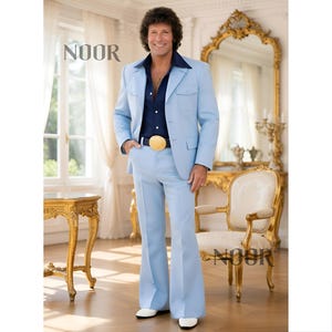 May include: A light blue suit with a navy blue shirt and a gold belt buckle. The suit has a jacket with two front pockets and flared pants. The image includes the text "NOOR".