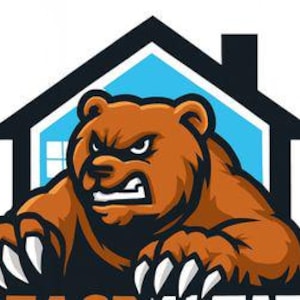 May include: A brown bear with an angry expression, sharp claws, and a black outline. The bear is positioned in front of a house silhouette with a blue background and white windows. The text "BEACH" is visible at the bottom.