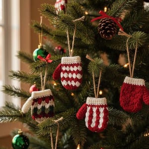 May include: A decorated Christmas tree featuring handmade crochet mitten decorations in red and white. The mittens are suspended by twine, with other baubles and a pine cone adding to the festive display.