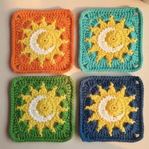 May include: Four crocheted squares in orange, teal, green, and blue. Each square features a sun and crescent moon design in yellow and white. The squares are handmade and have a textured appearance.