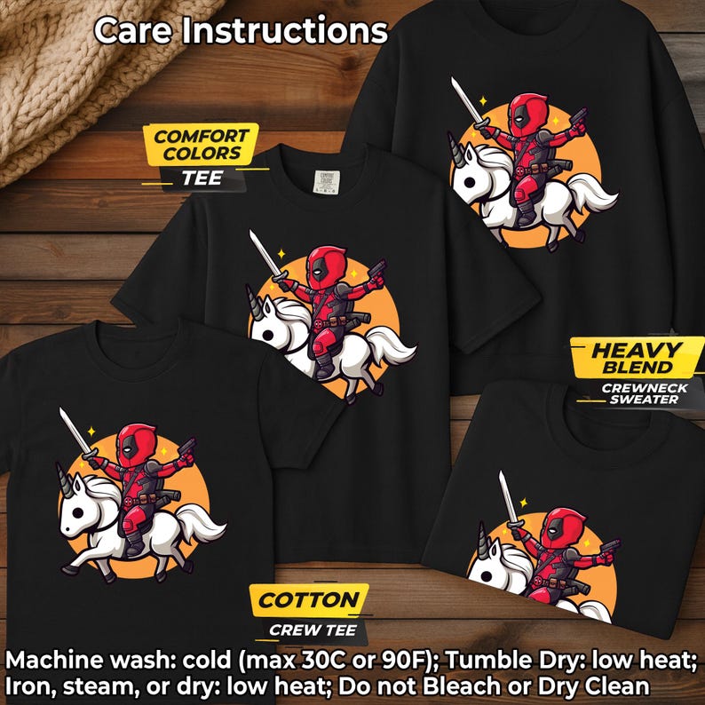 May include: Black t-shirts and a crewneck sweater featuring a cartoon Deadpool character riding a unicorn. The design includes a sword and an orange background. The image also displays care instructions and fabric type labels.