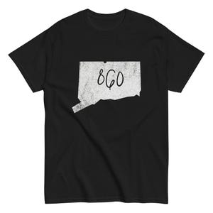 May include: Black t-shirt featuring a white outline of the state of Connecticut with the number "860" in the center. The graphic has a distressed, vintage look. The shirt is made of a soft material.