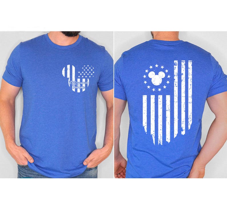 May include: Blue t-shirt featuring a white Mickey Mouse-shaped design with a stars and stripes pattern and the text "250 Years of Freedom" on the front. The back of the shirt displays a distressed American flag design.