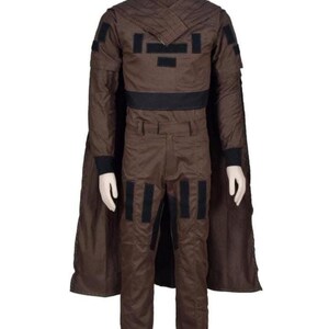 May include: A brown costume with a high collar, black accents, and a cape. The outfit includes a jacket with black patches, matching pants, and a black belt. The costume is displayed on a mannequin.