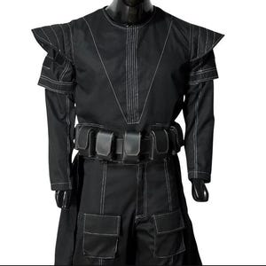 May include: Black costume with white stitching. The outfit has a high collar, structured shoulders, long sleeves, and a belt with pouches. The trousers have large pockets. The costume is displayed on a mannequin.