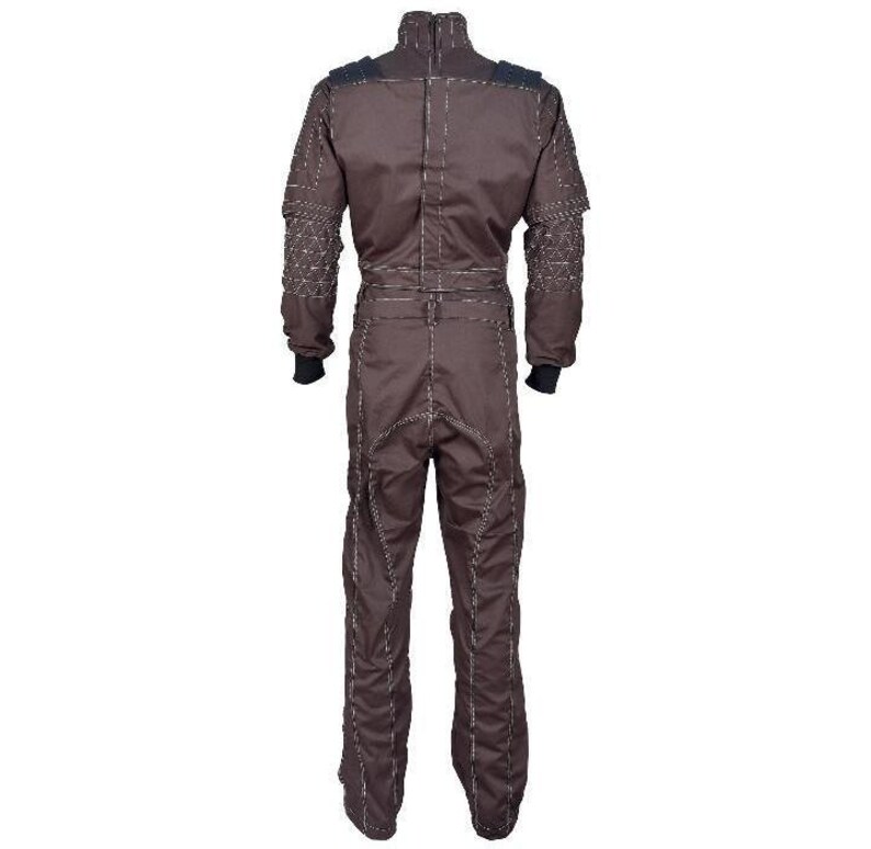 May include: A dark brown jumpsuit featuring a high collar, long sleeves with black ribbed cuffs, and a waist belt. The garment is detailed with prominent light-colored topstitching along the seams and a geometric quilted pattern on the shoulders.
