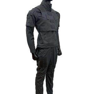 May include: A black tactical outfit displayed on a mannequin. The outfit includes a high-collared jacket with shoulder and chest panels, long sleeves, and matching pants with pockets. The ensemble is designed for a functional, utilitarian aesthetic.