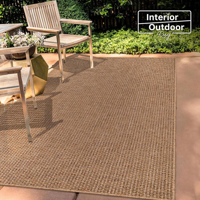 Flat-lay photo of a 160x230 cm beige rug on a tiled floor. The natural-looking texture enhances the overall warmth of the space and provides a stylish yet functional base layer for any room.