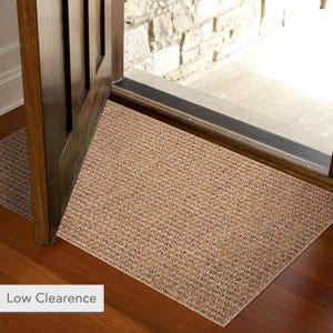Entryway decorated with a compact 60x100 cm beige rug. Ideal as a doormat or hallway accent rug thanks to its washable and non-slip features. Provides warmth, texture, and floor protection in transitional spaces.