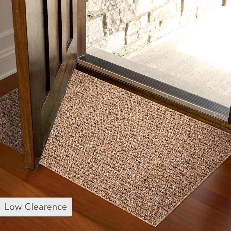 Entryway decorated with a compact 60x100 cm beige rug. Ideal as a doormat or hallway accent rug thanks to its washable and non-slip features. Provides warmth, texture, and floor protection in transitional spaces.
