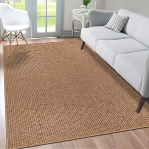 Covered patio scene with an 80x150 cm beige rug under a coffee table and chairs. The weatherproof design and soft texture make it a versatile option for entertaining or lounging outdoors.