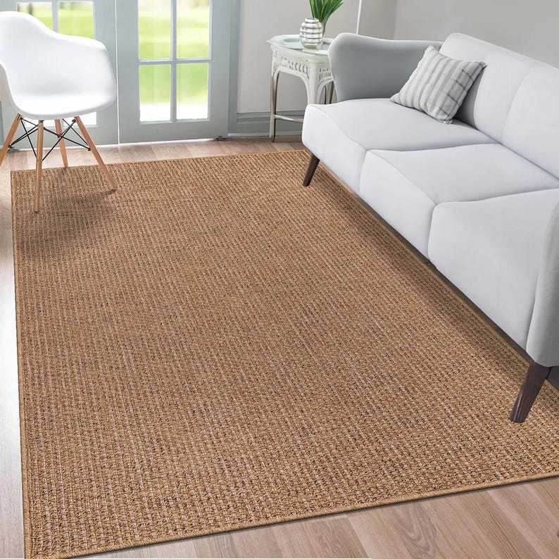Covered patio scene with an 80x150 cm beige rug under a coffee table and chairs. The weatherproof design and soft texture make it a versatile option for entertaining or lounging outdoors.