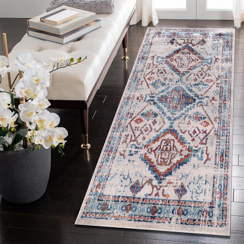 Hallway rug with blue and red tones on dark wood flooring