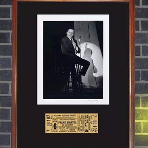 Peut inclure: Photographie encadrée en noir et blanc de Frank Sinatra sur scène, avec un billet de concert en dessous. Le billet est pour un concert du 6 mai 1975 au Market Square Arena à Indianapolis.