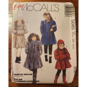 May include: An Easy McCall's 5085 sewing pattern envelope for children's coats. The front displays four illustrations of children wearing different coat styles: a leopard print coat, a solid blue coat, a grey faux fur coat, and a red hooded coat.