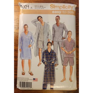 May include: Simplicity 1021 sewing pattern envelope featuring illustrations of loungewear including a V-neck nightshirt, a striped robe with shorts, a long-sleeve V-neck top with pants, and a plaid robe. The text includes Simplicity 1021 and easy-to-sew.