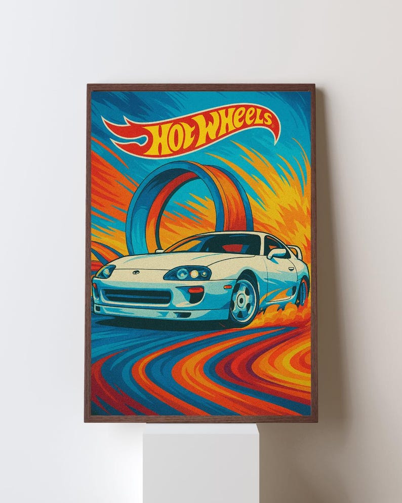 May include: A framed print featuring a white sports car speeding on a colorful track. The Hot Wheels logo is at the top, with a blue and orange background. The artwork has a retro style.