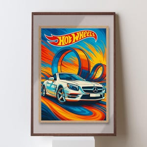 May include: A framed print featuring a white sports car with the Hot Wheels logo. The artwork has a dynamic design with blue, orange, and yellow swirls, and a loop-de-loop track. The print is in a brown frame.