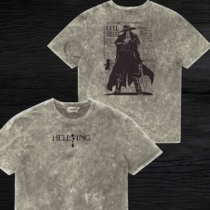 May include: Stone-washed grey t-shirts with a graphic design. One shirt features the word "HELLSING" and a cross. The other shirt displays a character illustration with the text "HELL BING" and Japanese text.