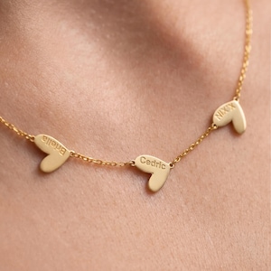 May include: A set of three ceramic mugs with a speckled, matte finish. Each mug features a different color: light blue, cream, and gray. The mugs have a simple, modern design and a comfortable handle.