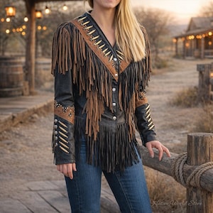 May include: Black leather jacket with brown fringe and accents. The jacket features a V-neck, button closure, and decorative studs. The sleeves and shoulders are adorned with fringe and decorative elements, creating a Western-inspired look.