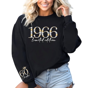 May include: Black sweatshirt with the year "1966" and the words "limited edition" in white script. The number is embellished with gold and silver-colored rhinestones. The left sleeve has a gold crown and the words "60 Chapter".