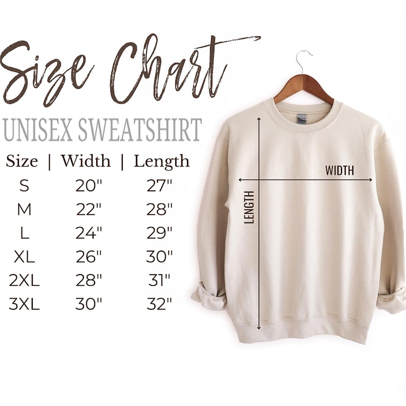 May include: A beige unisex sweatshirt hangs on a wooden hanger. The image includes a size chart with measurements in inches for width and length, ranging from size small to 3XL.