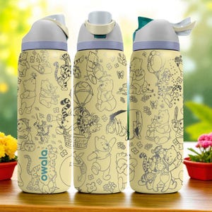May include: A yellow Owala water bottle featuring a repeating pattern of Winnie the Pooh and friends in black line art. The bottle has a gray lid and a teal flip-top. The bottle is on a wooden surface.