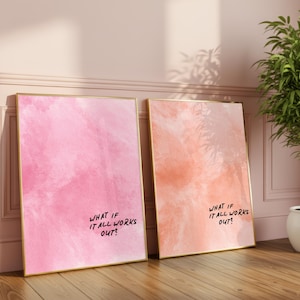 May include: Two framed art prints with gold frames. One print features a pink watercolor design, the other a peach watercolor design. Both prints have the text "WHAT IF IT ALL WORKS OUT?" in black script.