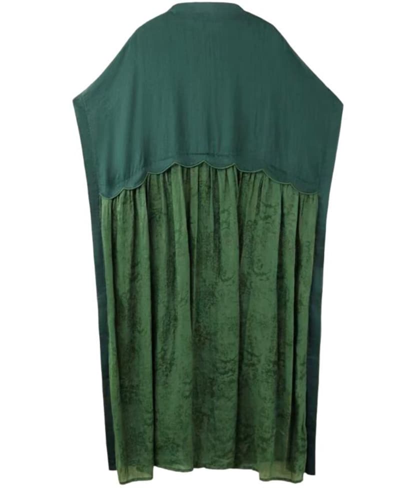 May include: A loose-fitting tunic in two shades of green. The upper section is a solid dark forest green with a smooth texture, while the lower section is a lighter olive green with a subtle, tonal floral pattern, joined by a scalloped seam.
