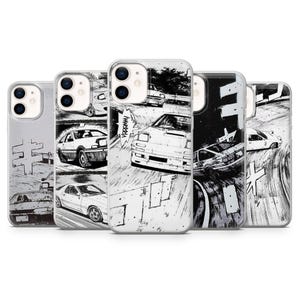 May include: A collection of phone cases featuring black and white manga-style illustrations of cars racing. The cases showcase various car models in dynamic action scenes, with Japanese sound effects.