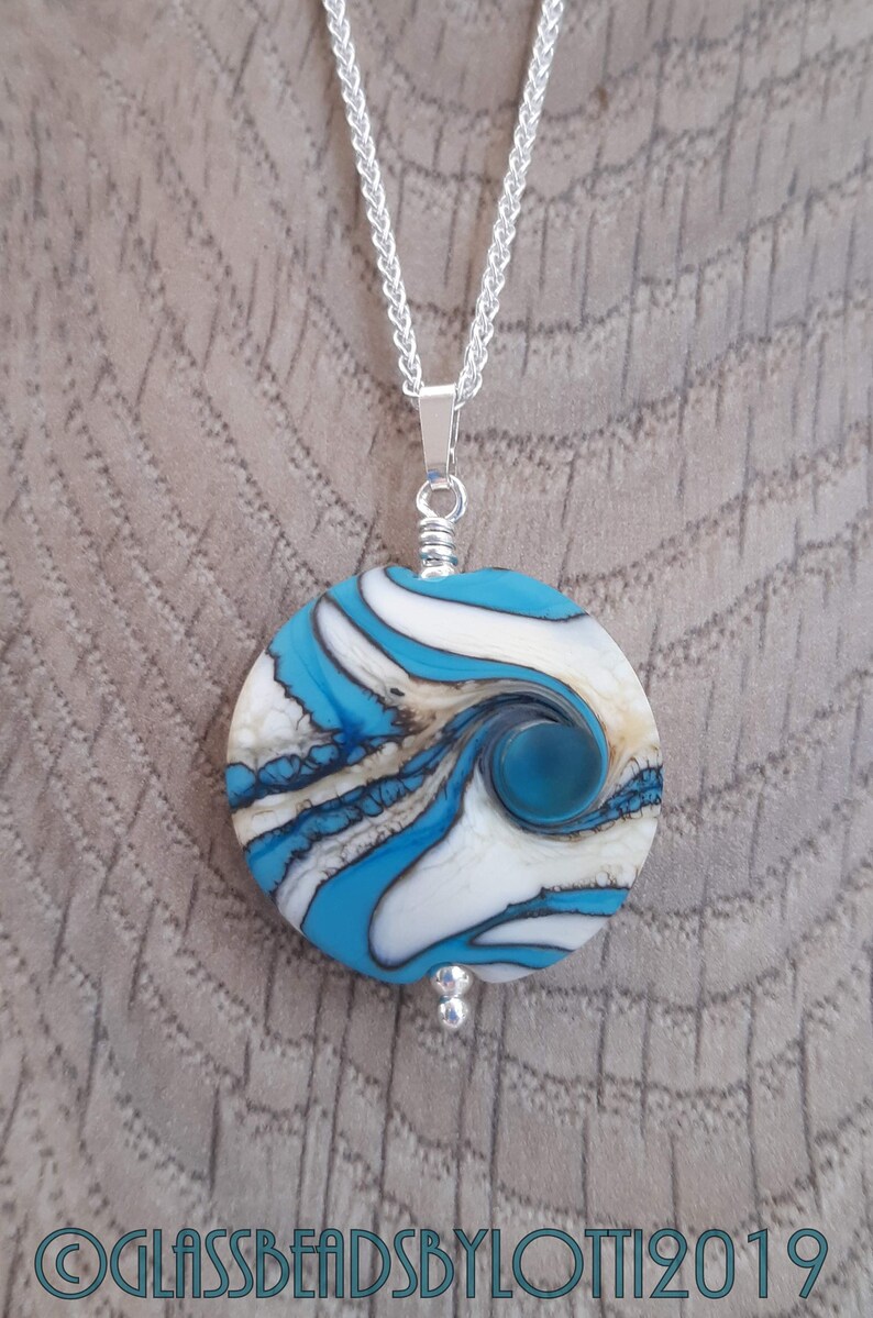 Opaque turquoise and ivory bead necklace on silver chain