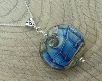 Blue handcrafted organic lampwork glass bead necklace on a sterling silver chain.