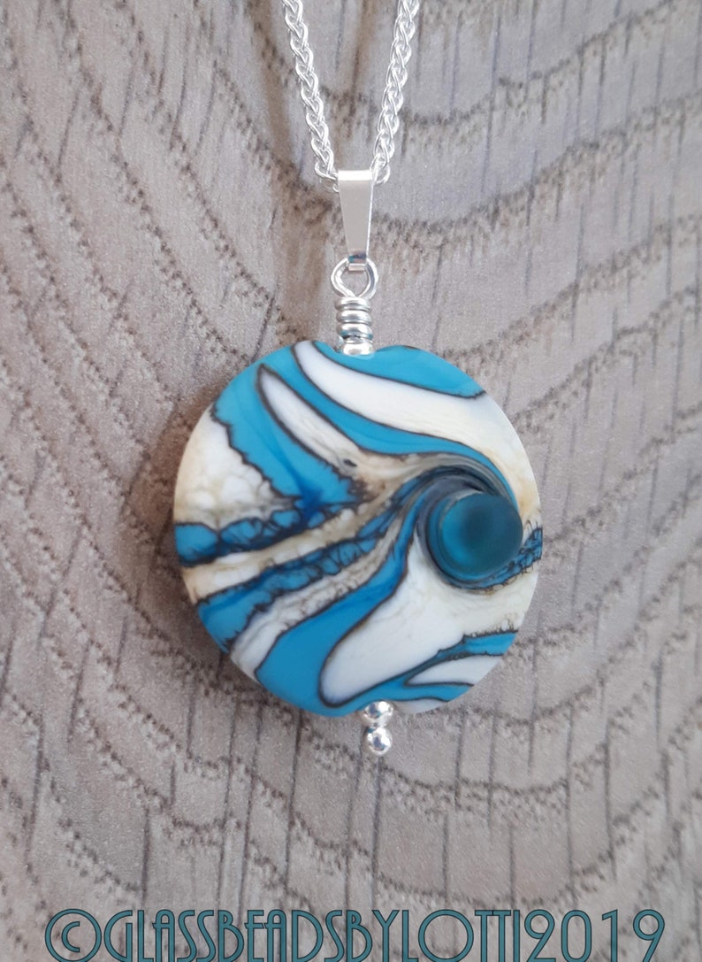 Opaque turquoise and ivory bead necklace on silver chain