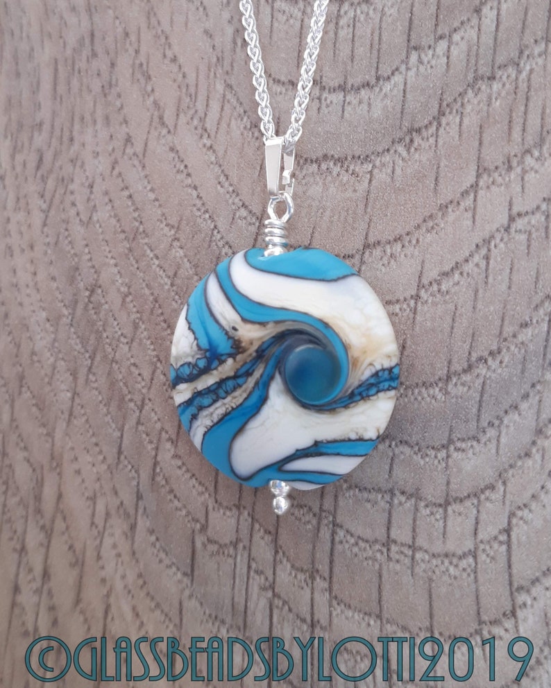 Opaque turquoise and ivory bead necklace on silver chain
