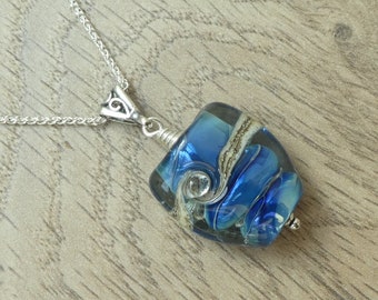 Blue handcrafted organic lampwork glass bead necklace on a sterling silver chain.