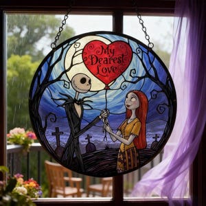 May include: Round stained glass window featuring Jack Skellington and Sally from The Nightmare Before Christmas. Jack holds a red heart-shaped balloon with the words "My Dearest Love". The background shows a graveyard and a full moon.